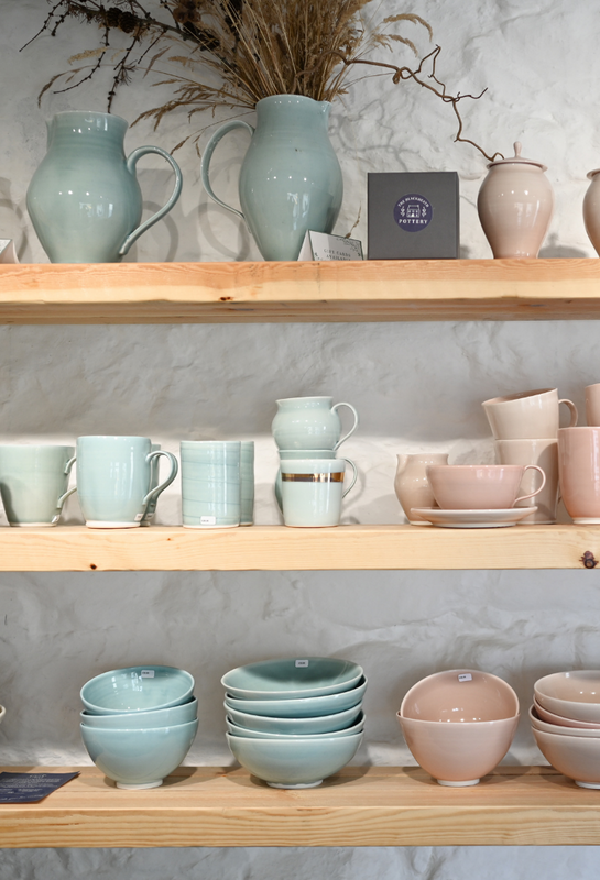 The Blackheath Pottery shelves, Filled with handmade porcelain pottery glazed in fresh contemporary colours, Celadon Blue and Blush Pink